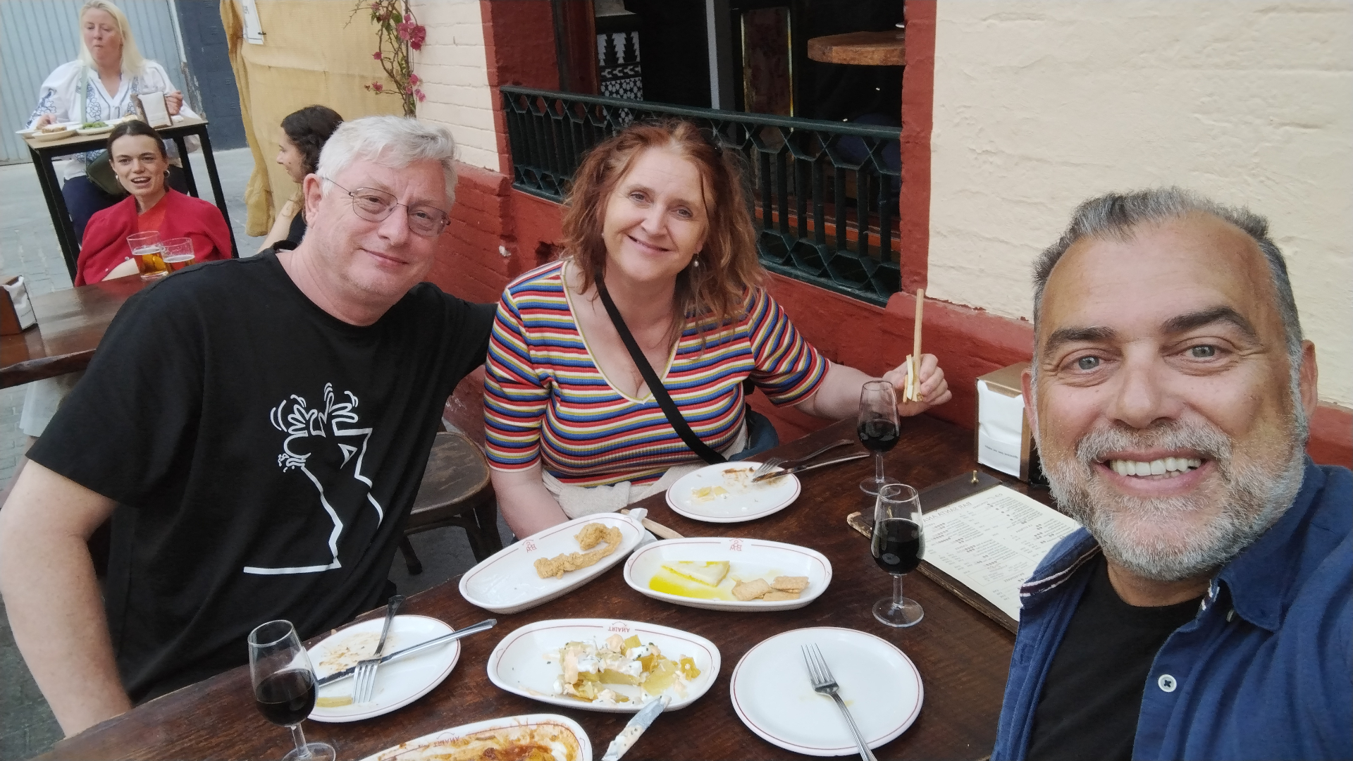 Johnny with guests enjoying tapas and wine outdoors