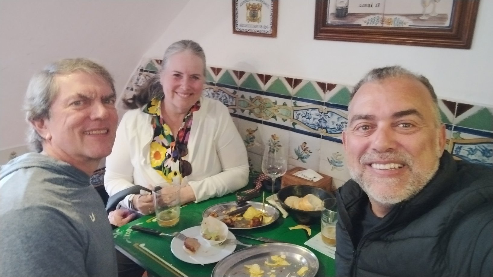 Johnny sharing tapas with guests in a tiled tavern