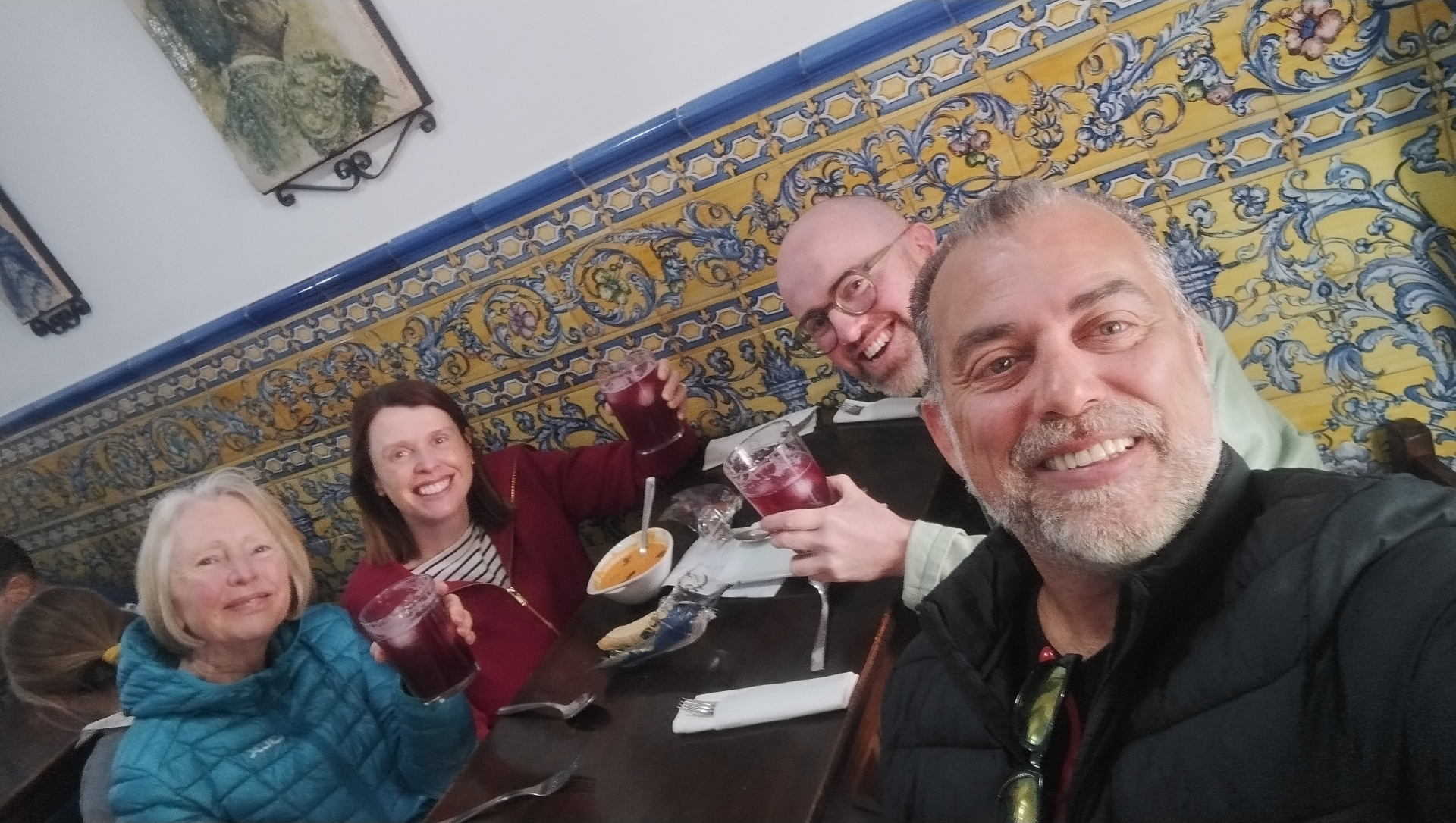Johnny with guests toasting tinto de verano over tapas