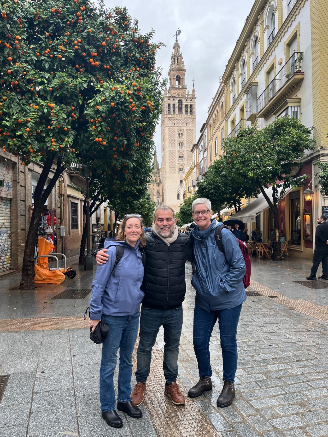 Johnny with guests near the Giralda and orange trees