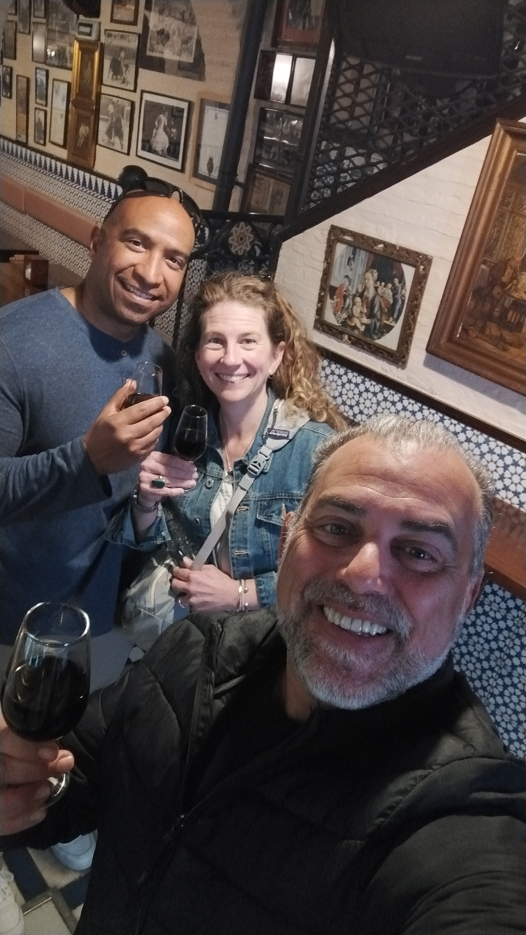 Johnny sharing wine with guests in a historic bar