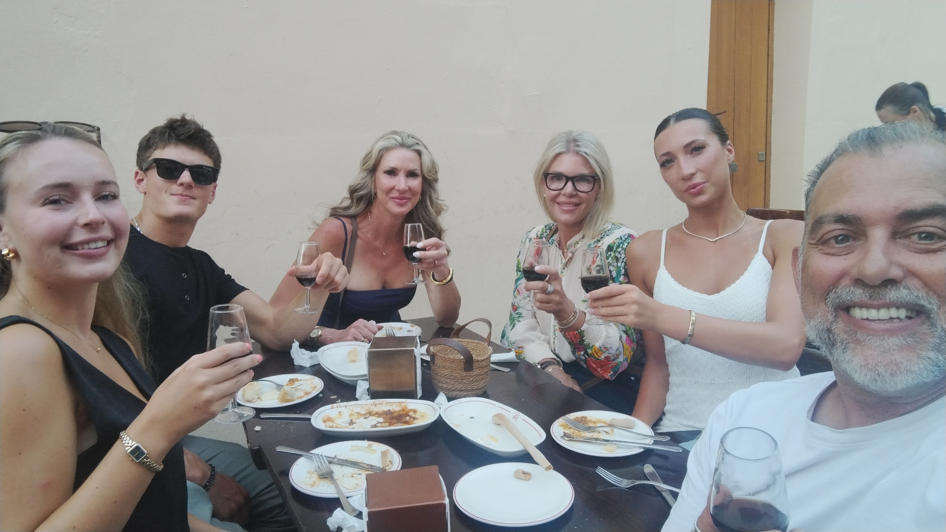 Johnny and guests toasting with wine over tapas in Seville