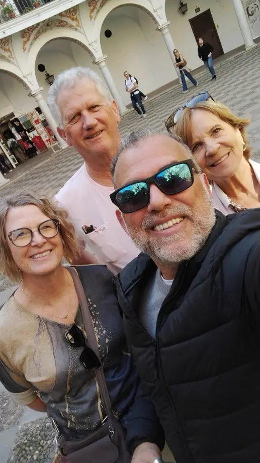 Family of guests in a Sevillian courtyard